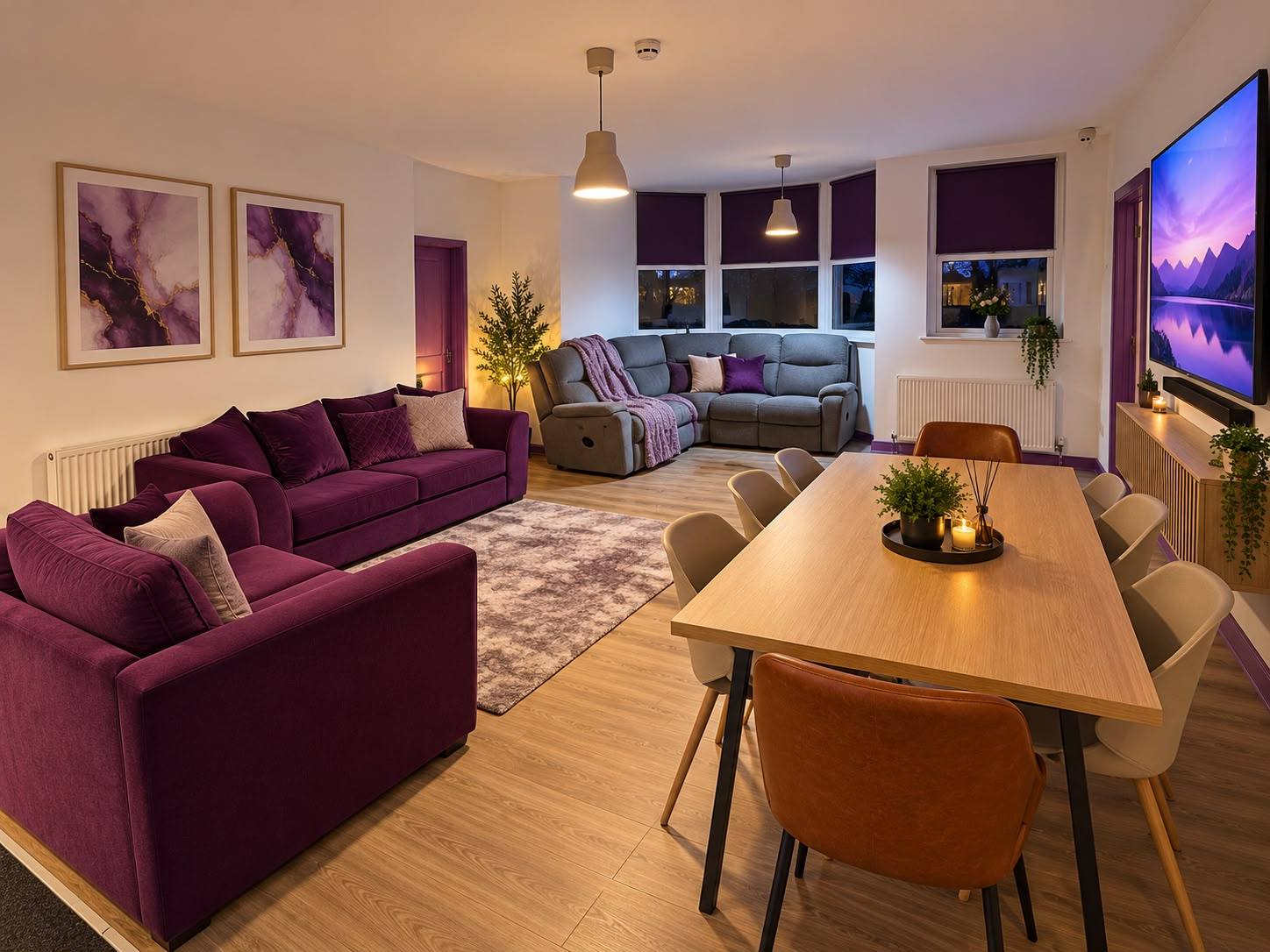 Our shared lounge and dining room, with purple sofas, a corner sofa and a dining table.